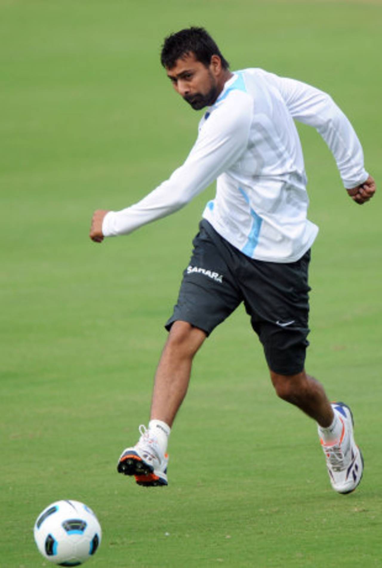 Praveen Kumar warms up with a game of football, October 12, 2011