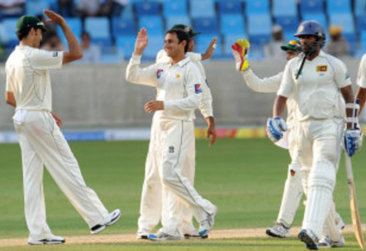Pakistan celebrate after dismissing Chanaka Welegedara and bowling Sri Lanka out for 239, Pakistan v Sri Lanka, 2nd Test, Dubai, 1st day, October 26, 2011 