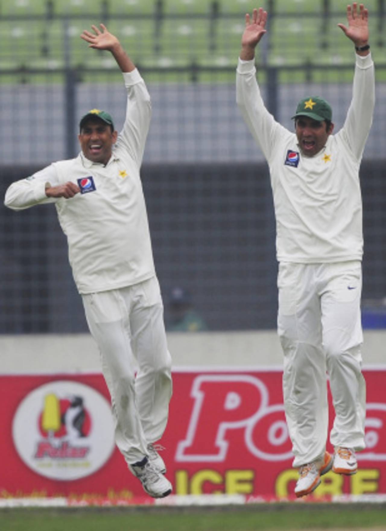 Younis Khan and Misbah-ul-Haq are delighted after the fall of Nasir Hossain, Bangladesh v Pakistan, 2nd Test, Mirpur, 1st day, December 17, 2011 