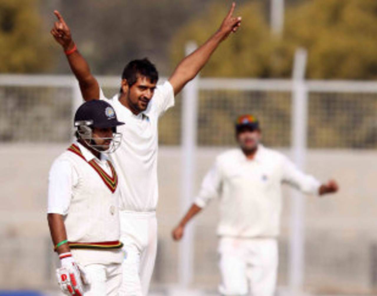 Amit Mishra looks dejected as Pankaj Singh celebrates one of his four strikes, 1st semi-final, Ranji Trophy 2011-12, Lahli, 3rd day, January 12, 2012