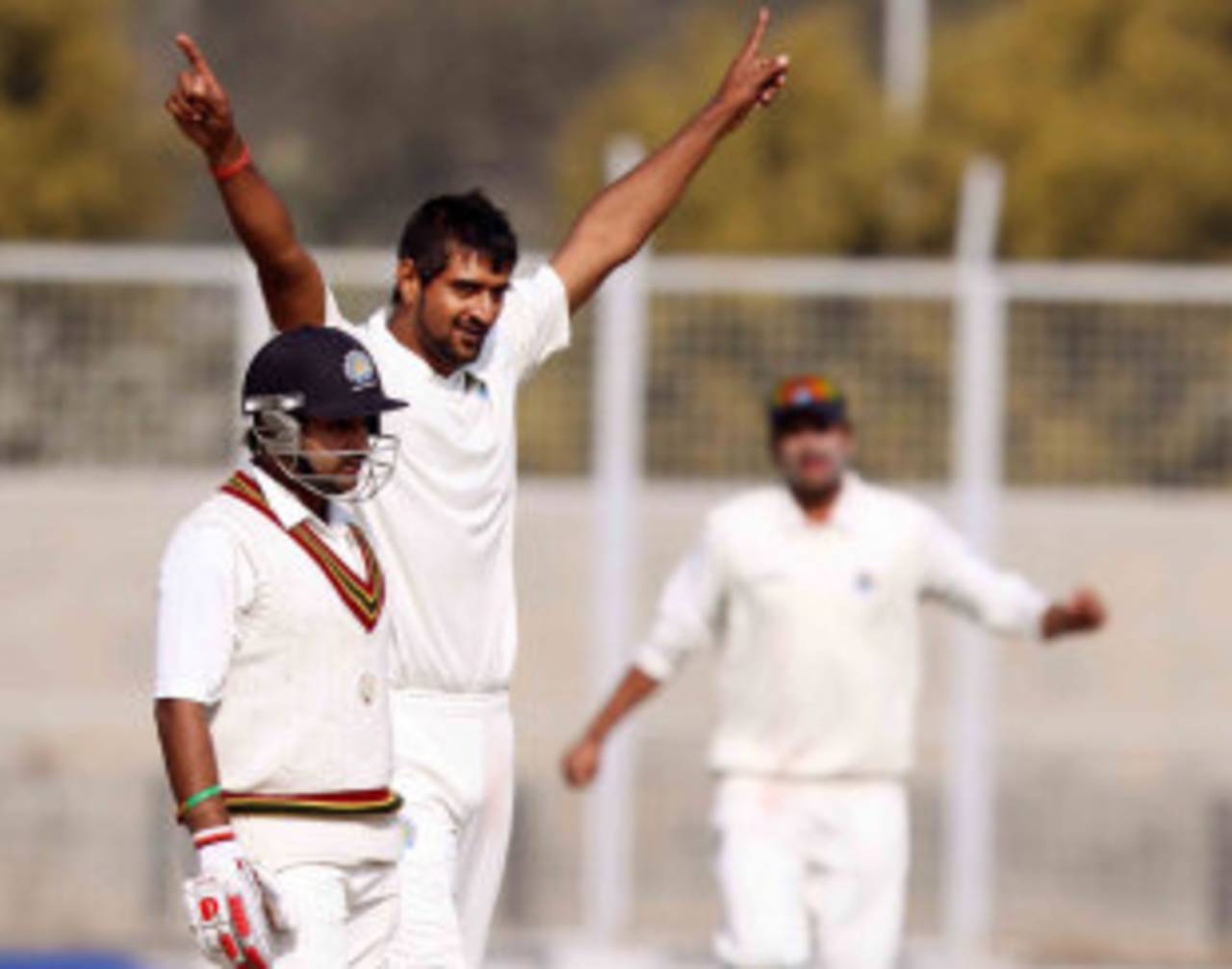 Amit Mishra looks dejected as Pankaj Singh celebrates one of his four strikes, 1st semi-final, Ranji Trophy 2011-12, Lahli, 3rd day, January 12, 2012 