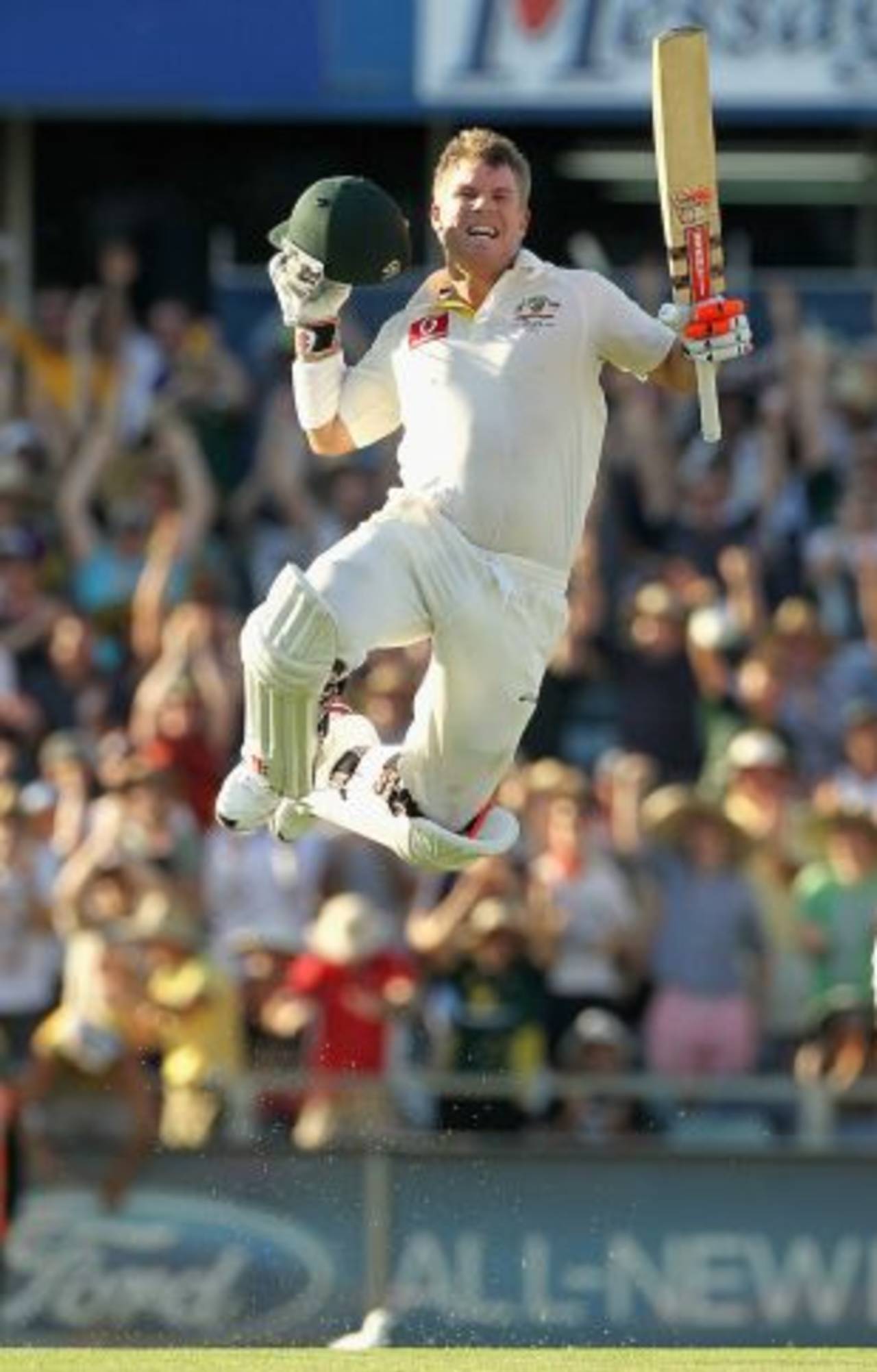 David Warner takes off after reaching his century with a six off his 69th ball, Australia v India, 3rd Test, Perth, 1st day, January 13, 2012