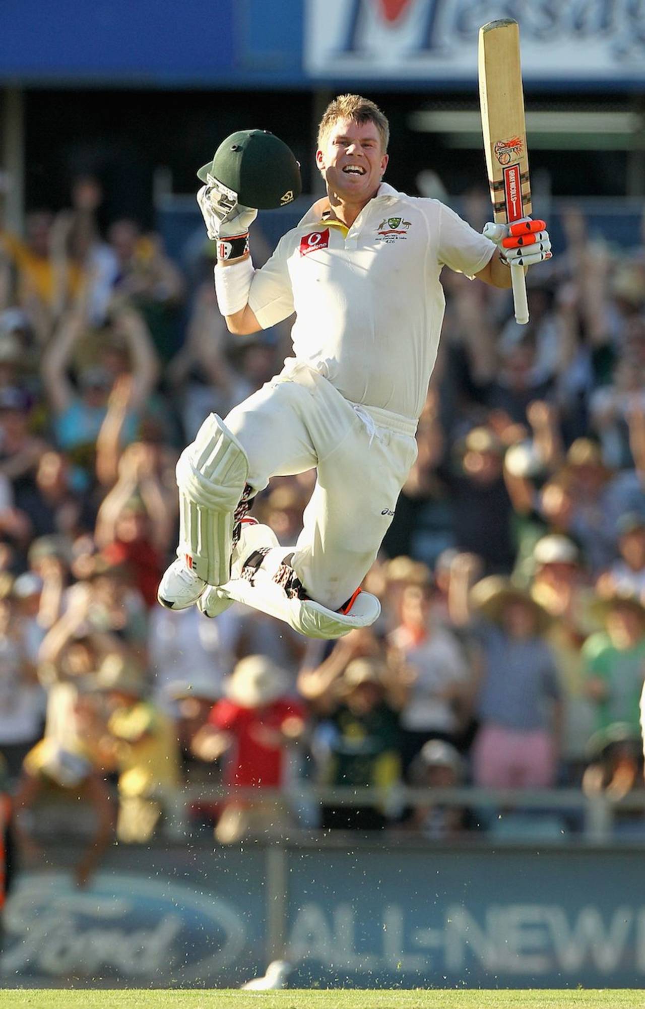 David Warner takes off after reaching his century with a six off his 69th ball, Australia v India, 3rd Test, Perth, 1st day, January 13, 2012