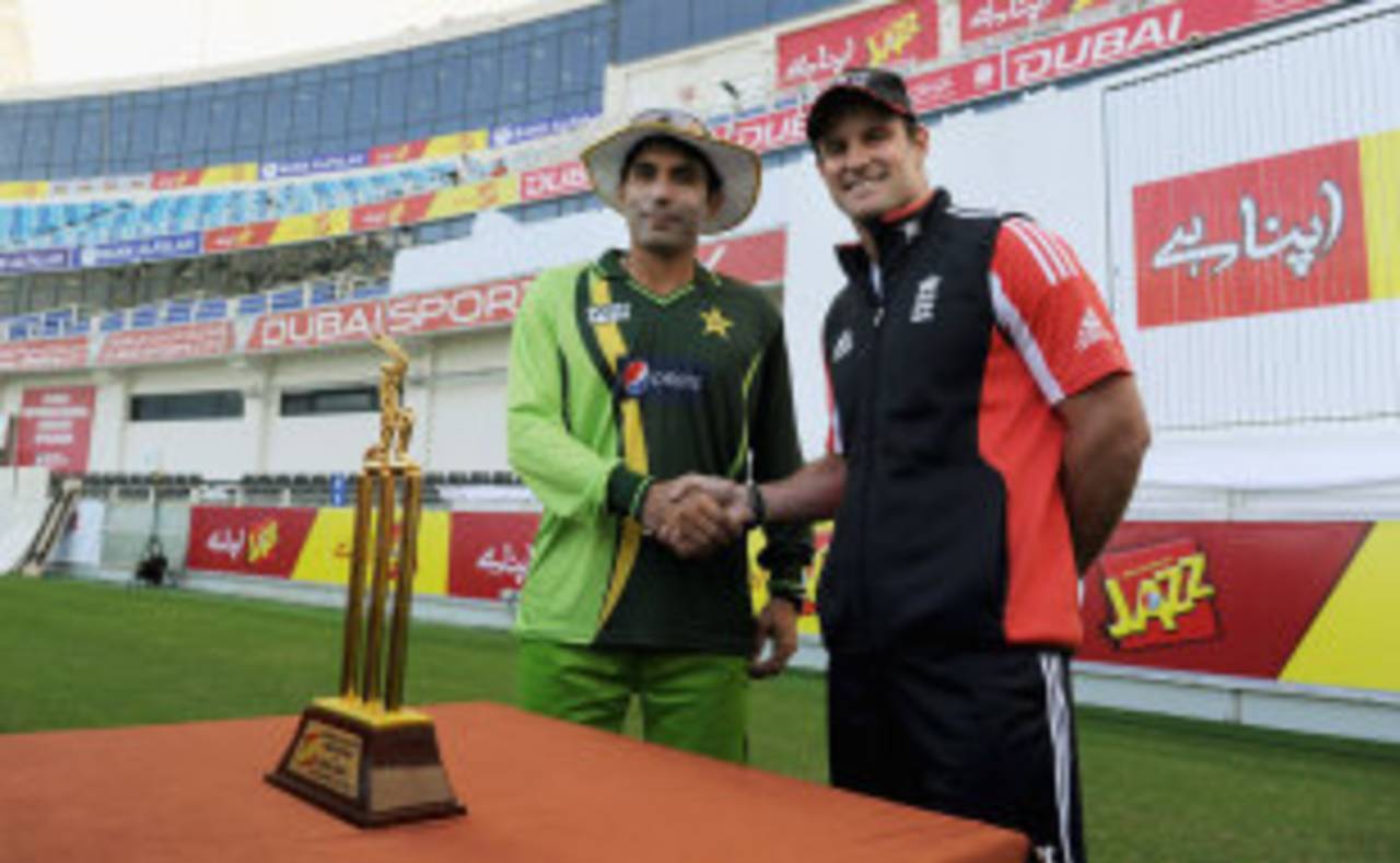 Pakistan captain Misbah-ul-Haq shakes hands with his England counterpart Andrew Strauss over the series trophy, Dubai, January 16, 2012