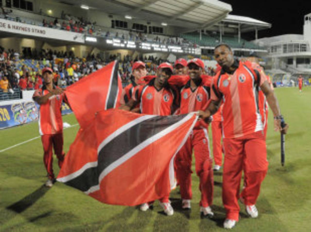 Trinidad & Tobago's players wave their flag after their win, Jamaica v Trinidad & Tobago, final, Caribbean T20 2011-12, Bridgetown, January 22, 2012