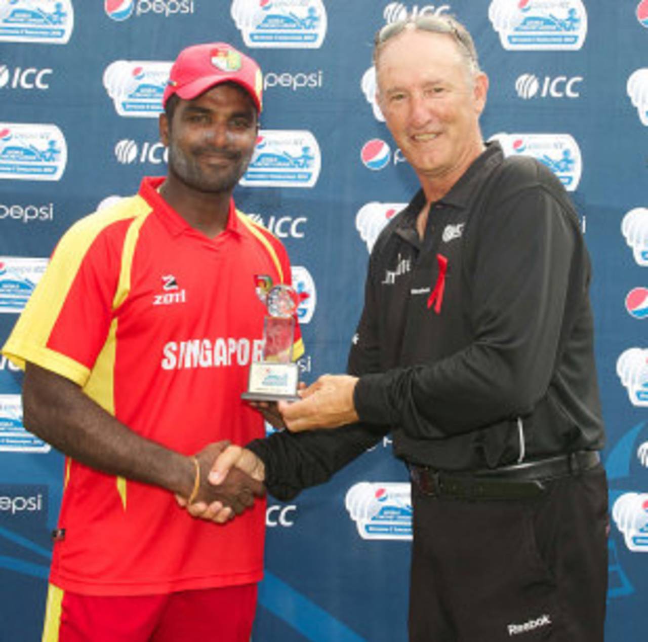 Chaminda Ruwan receives the Player of the match award from Tony Hill, Singapore v Malaysia, ICC World Cricket League Division Five final, Singapore, February 25, 2012