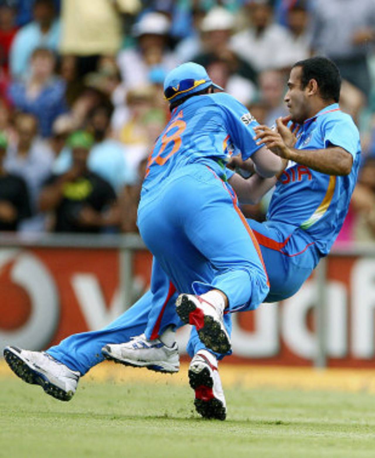 Suresh Raina collides with Irfan Pathan in the process of catching David Warner, Australia v India, CB Series, Sydney, February 26, 2012
