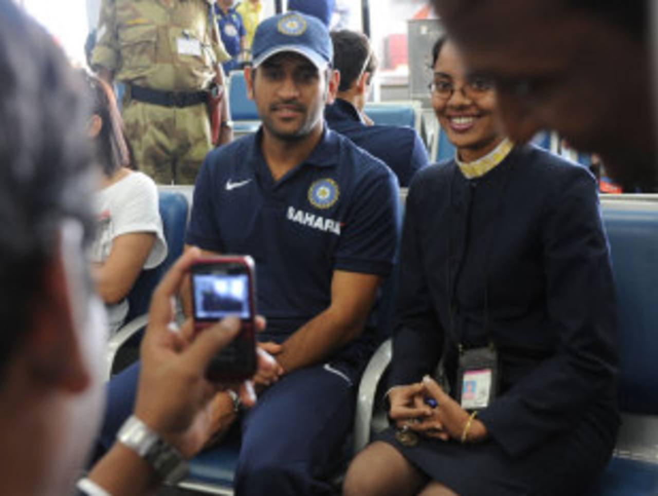 MS Dhoni poses for a photo with a flight attendant, Visakhapatnam, October 21, 2010