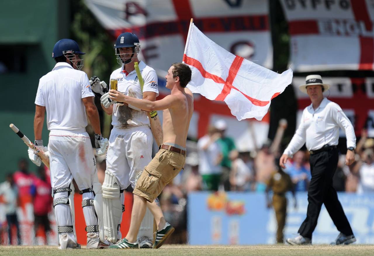 An England fan joins Kevin Pietersen and Alastair Cook in the middle, Sri Lanka v England, 2nd Test, Colombo, P Sara Oval, 5th day, April 7, 2012