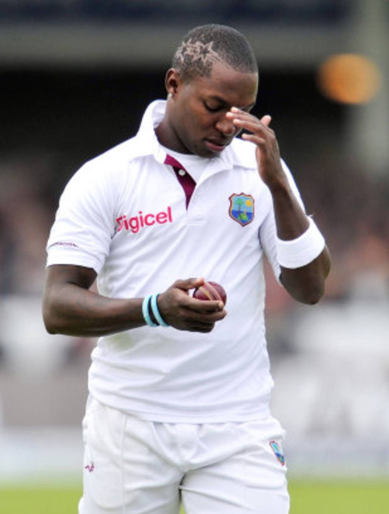 Fidel Edwards inspects the ball on a difficult day for West Indies' bowlers, England v West Indies, 1st Test, Lord's, 2nd day, May 18, 2012