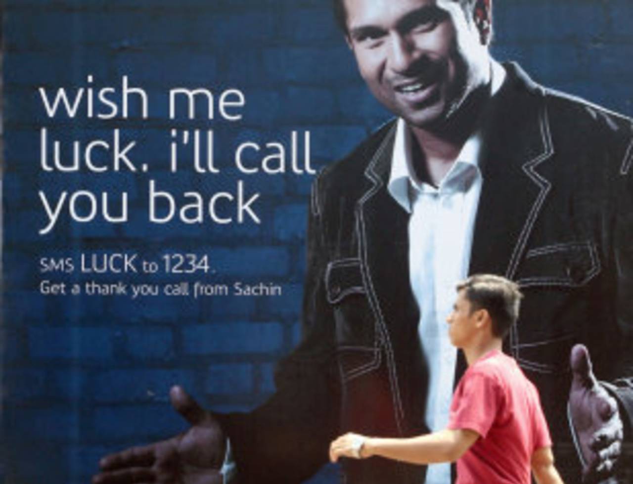 A man walks past a billboard featuring Sachin Tendulkar, Mumbai, March 19, 2007