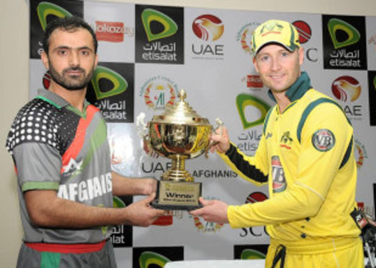 Afghanistan's Nawroz Mangal and Michael Clarke unveil the one-off ODI trophy, Sharjah, August 23, 2012