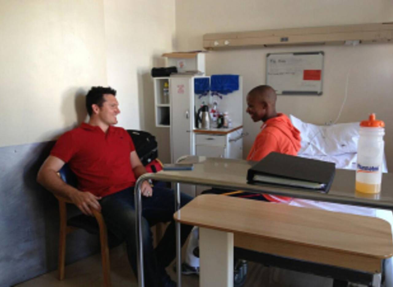 Graeme Smith with Mphetho Bidli, a boy recovering in hospital after being struck by lightning, Johannesburg, March 13, 2013