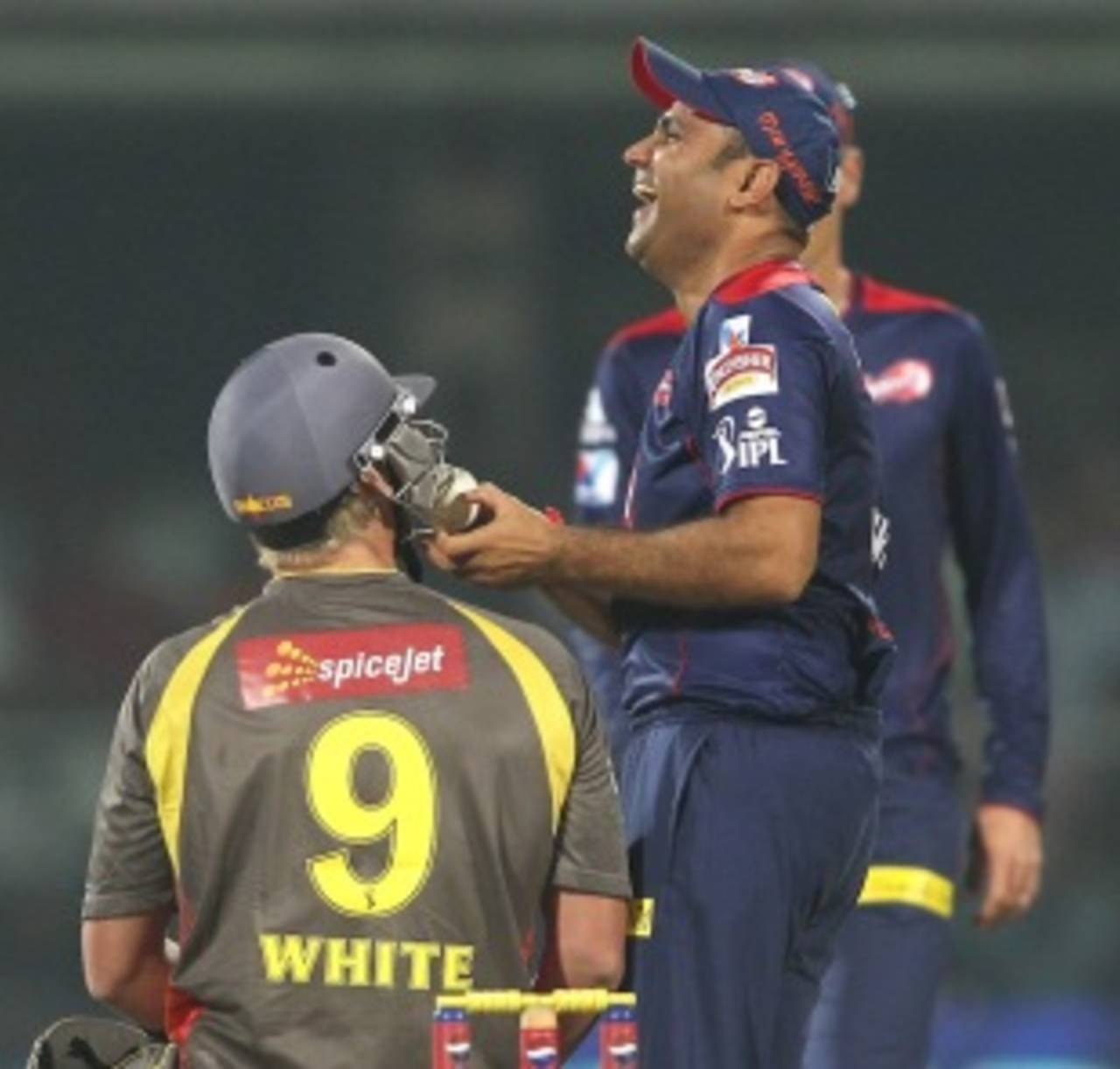 Virender Sehwag tries his luck at getting the ball unstuck from Cameron White's grille&nbsp;&nbsp;&bull;&nbsp;&nbsp;BCCI