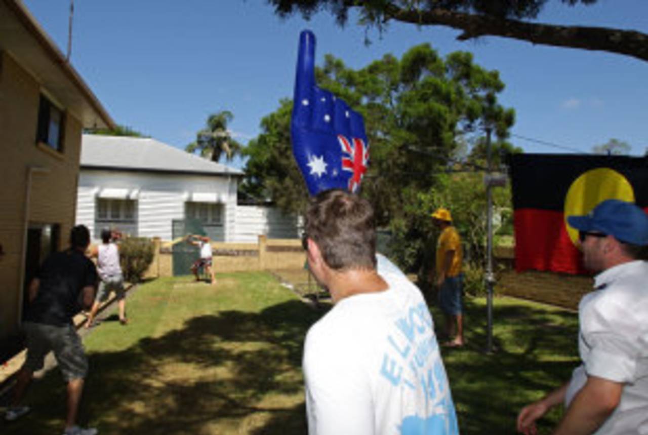 A group of friends plays a game of backyard cricket, Brisbane, January 26, 2011