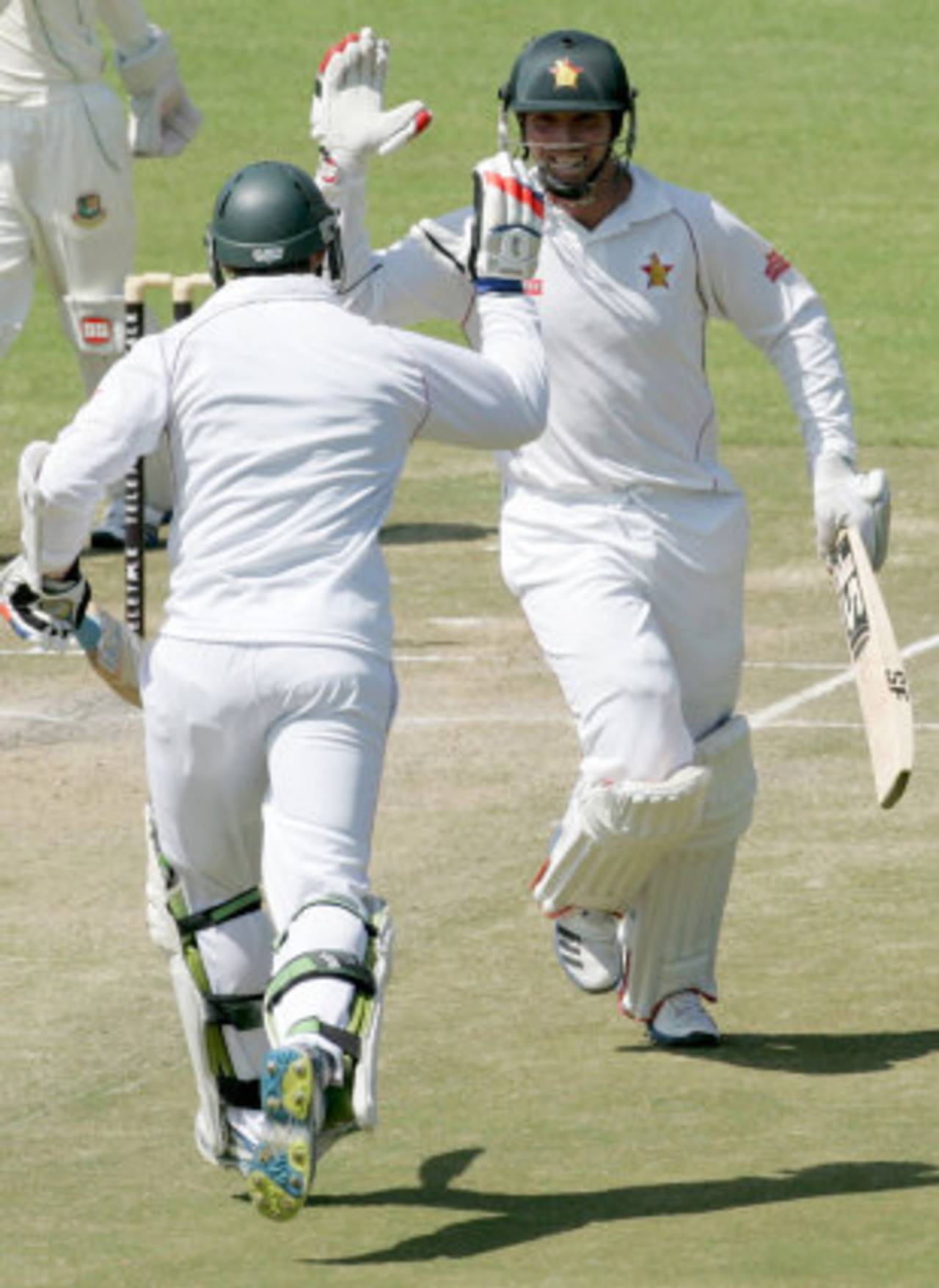 Brendan Taylor high-fives Keegan Meth as he completes another hundred, Zimbabwe v Bangladesh, 1st Test, 4th day, Harare, April 20, 2013