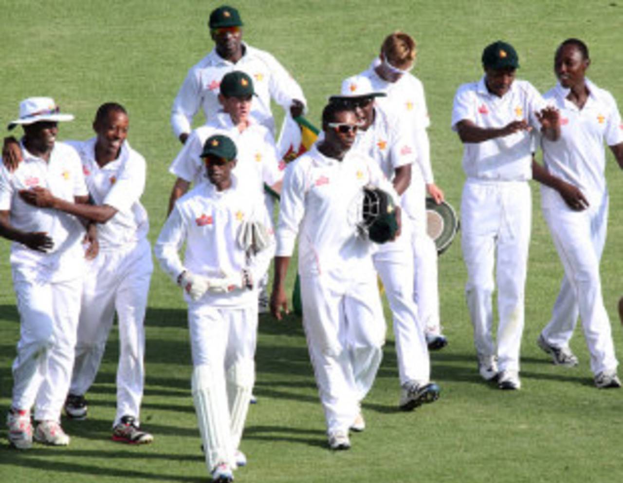 Zimbabwe walk off the pitch after their crushing victory, Zimbabwe v Bangladesh, 1st Test, 4th day, Harare, April 20, 2013