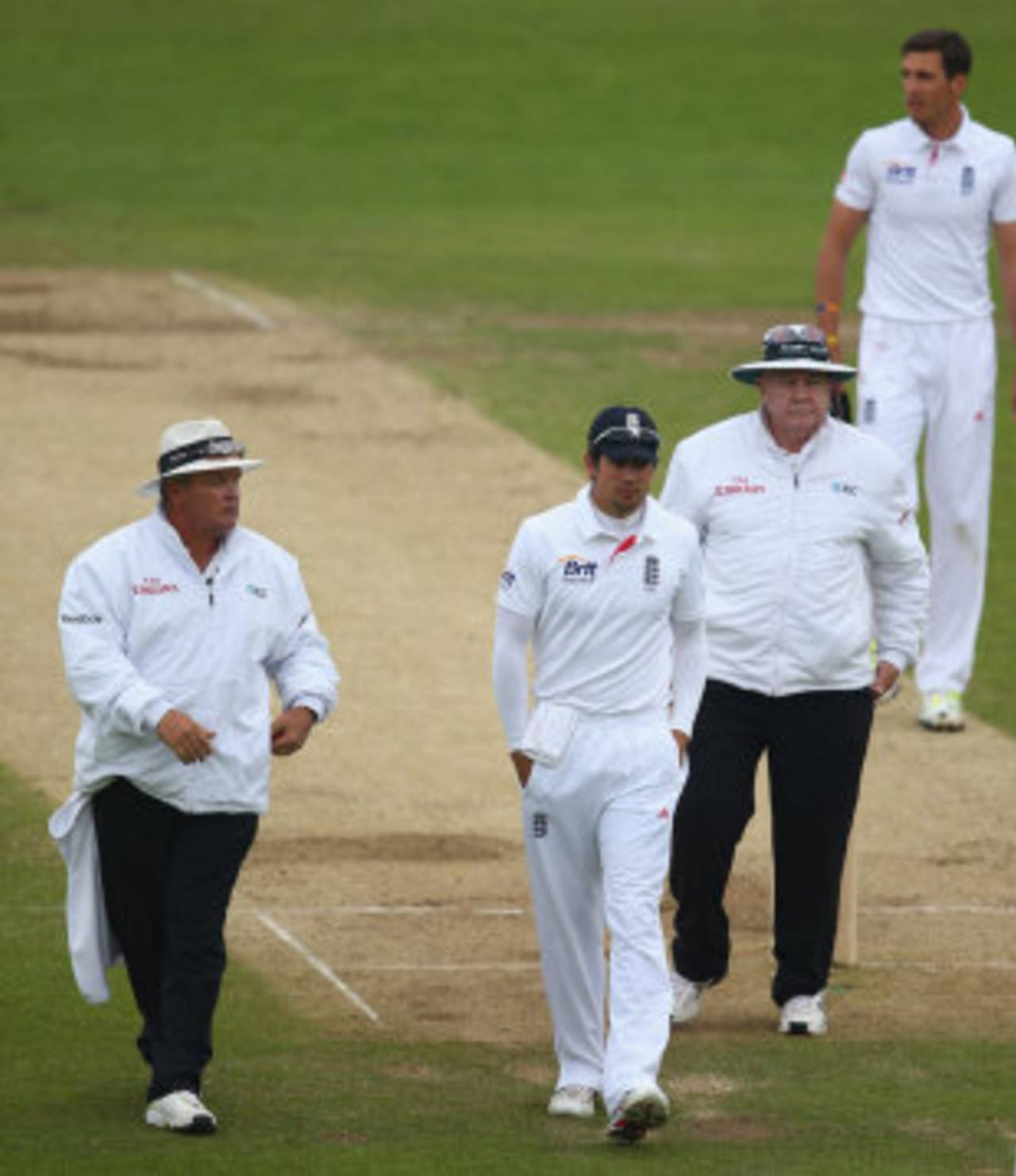 Alastair Cook leads his team off after a word with Marais Erasmus and Steve Davis, England v New Zealand, 2nd Investec Test, Headingley, 5th day, May 28, 2013