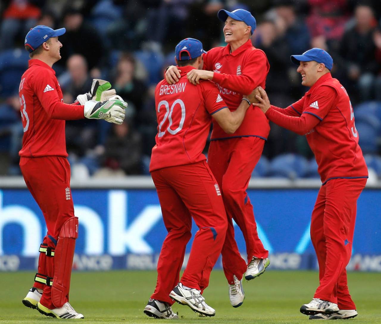 Team-mates hover around Joe Root after his splendid catch in the deep, England v New Zealand, Champions Trophy, Group A, Cardiff, June 16, 2013