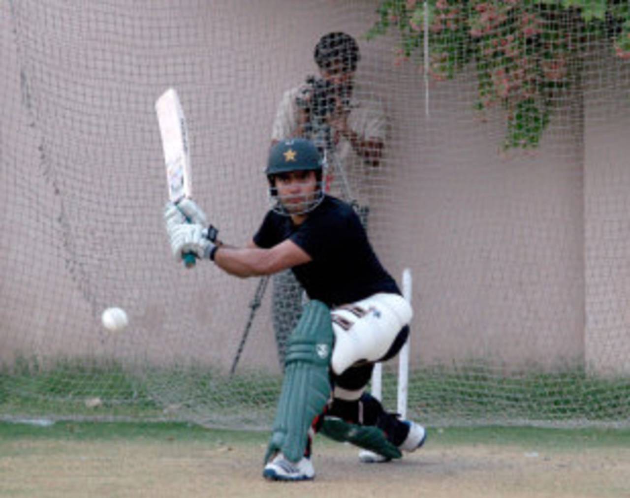 Umar Akmal has a bat in the nets, Lahore, July 2, 2013