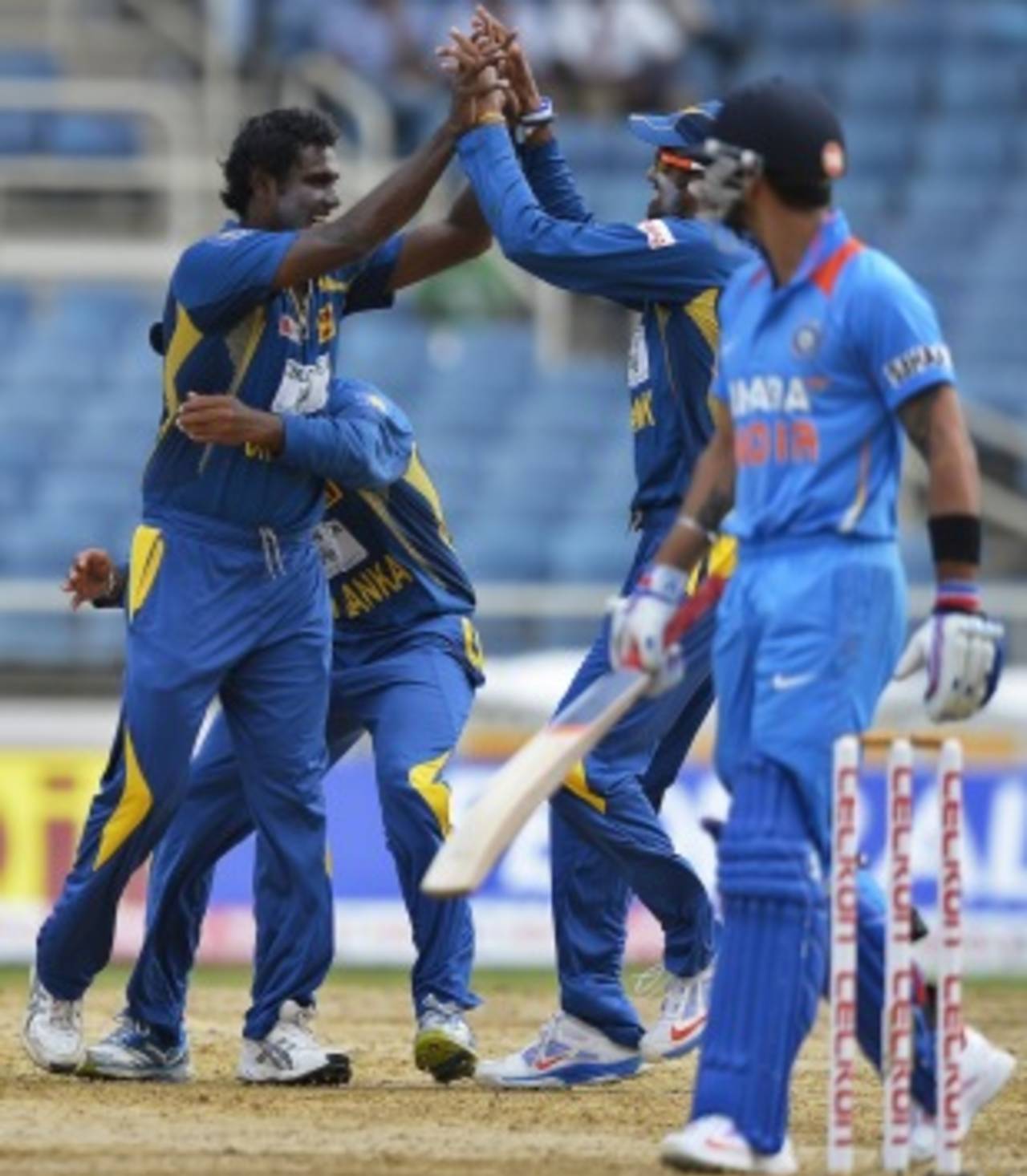 Angelo Mathews is mobbed after removing Virat Kohli, India v Sri Lanka, West Indies tri-series, Kingston, July 2, 2013