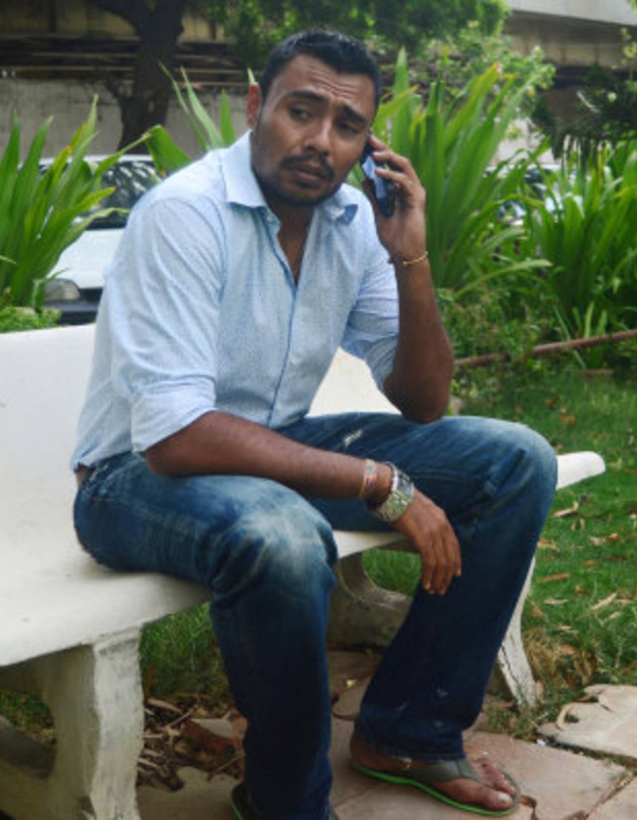 Danish Kaneria on the phone outside his apartment, Karachi, July 5, 2013
