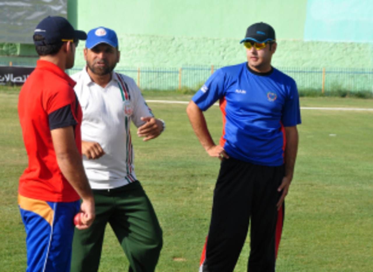 Afghanistan coach Kabir Khan advises players at a training camp, Kabul, July 23, 2013