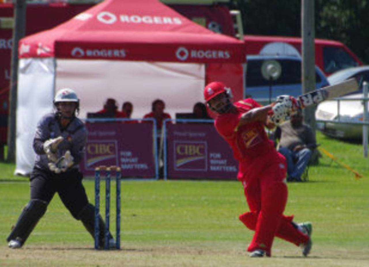 Hiral Patel lofts the ball during his half-century, Canada v UAE, ICC World Cricket League Championship, King City, August 8, 2013