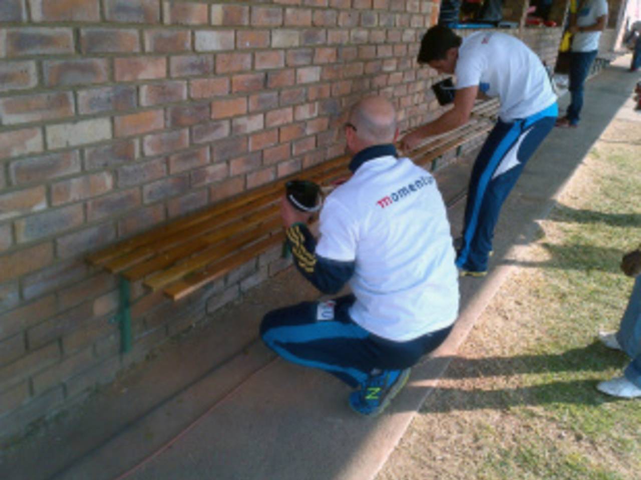 Titans players paint benches at the Mamelodi Cricket Club, Tshwane, August 2013
