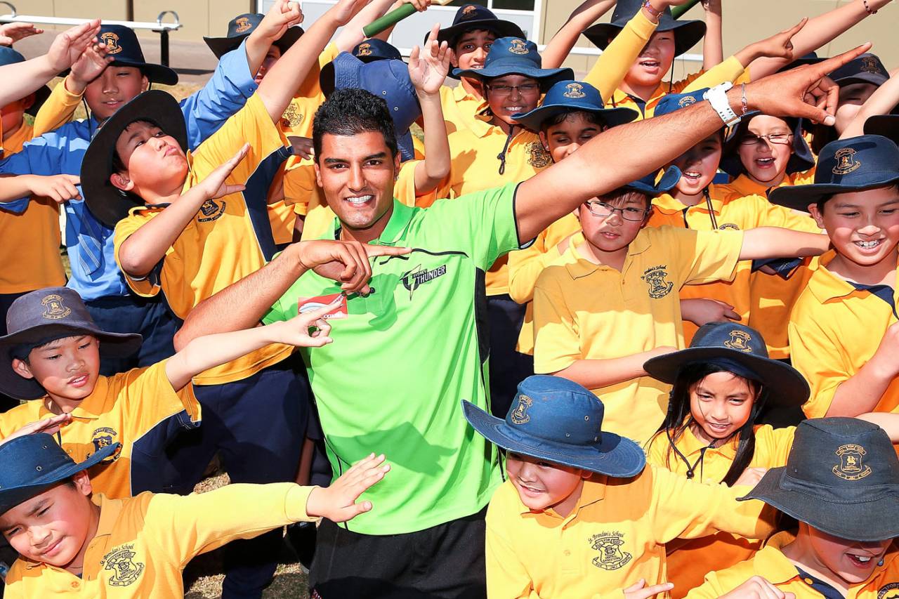 Gurinder Sandhu does the 'lightning Bolt' pose with kids at a Cricket Australia community event, Sydney, August 28, 2013