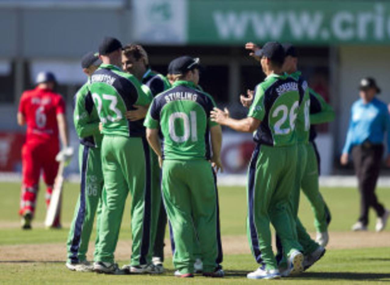 Ireland's players form a huddle around Tim Murtagh, Ireland v England, one-off ODI, Malahide, September 3, 2013