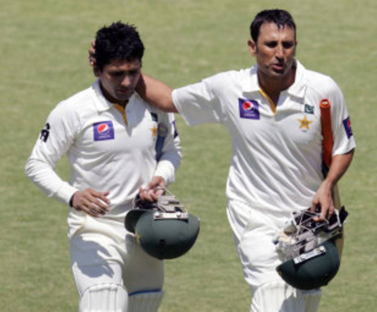 Younis Khan and Adnan Akmal walk off the pitch for the lunch break, Zimbabwe v Pakistan, 1st Test, 4th day, Harare, September 6, 2013