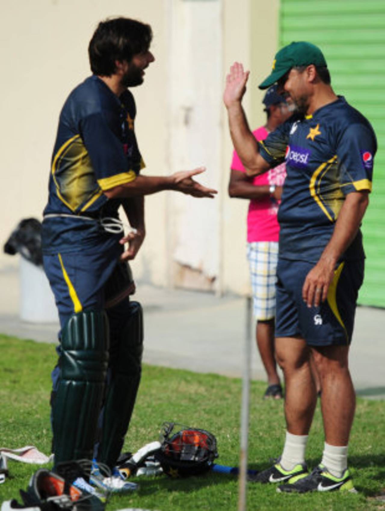 Shahid Afridi and team manager Moin Khan share a lighter moment during training, Sharjah, October 29, 2013