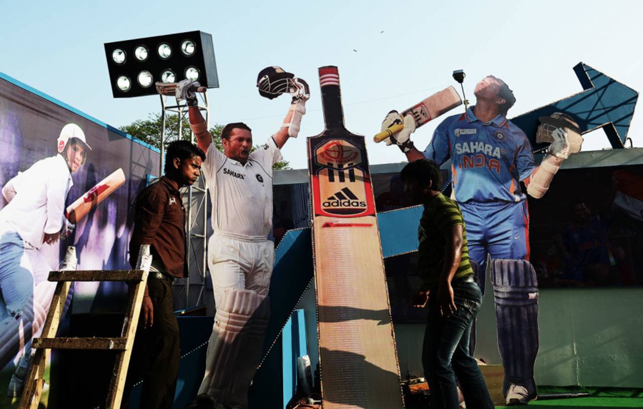 Workers place cut-outs of Sachin Tendulkar on a float in Kolkata, ahead of the first India West Indies Test, November 3, 2013