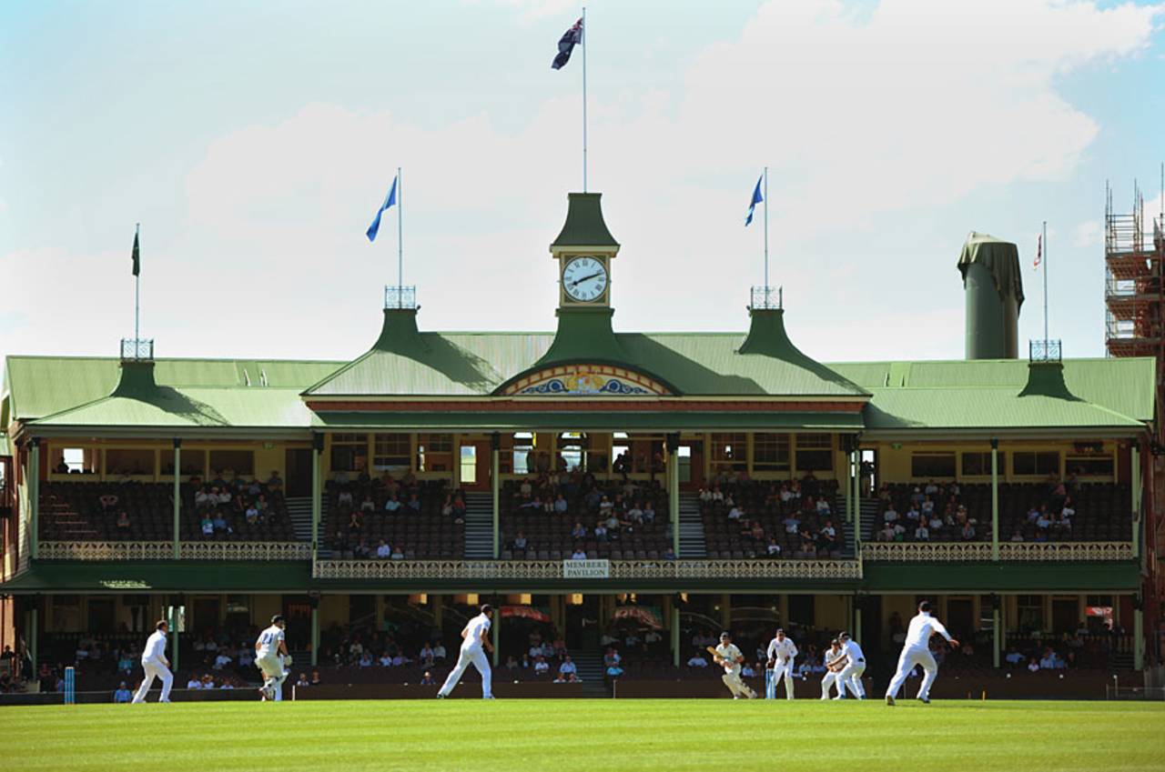 Graeme Swann bowls against the backdrop of the SCG pavilion, Cricket Australia Invitational XI v England, Sydney, 1st day, November 13, 2013