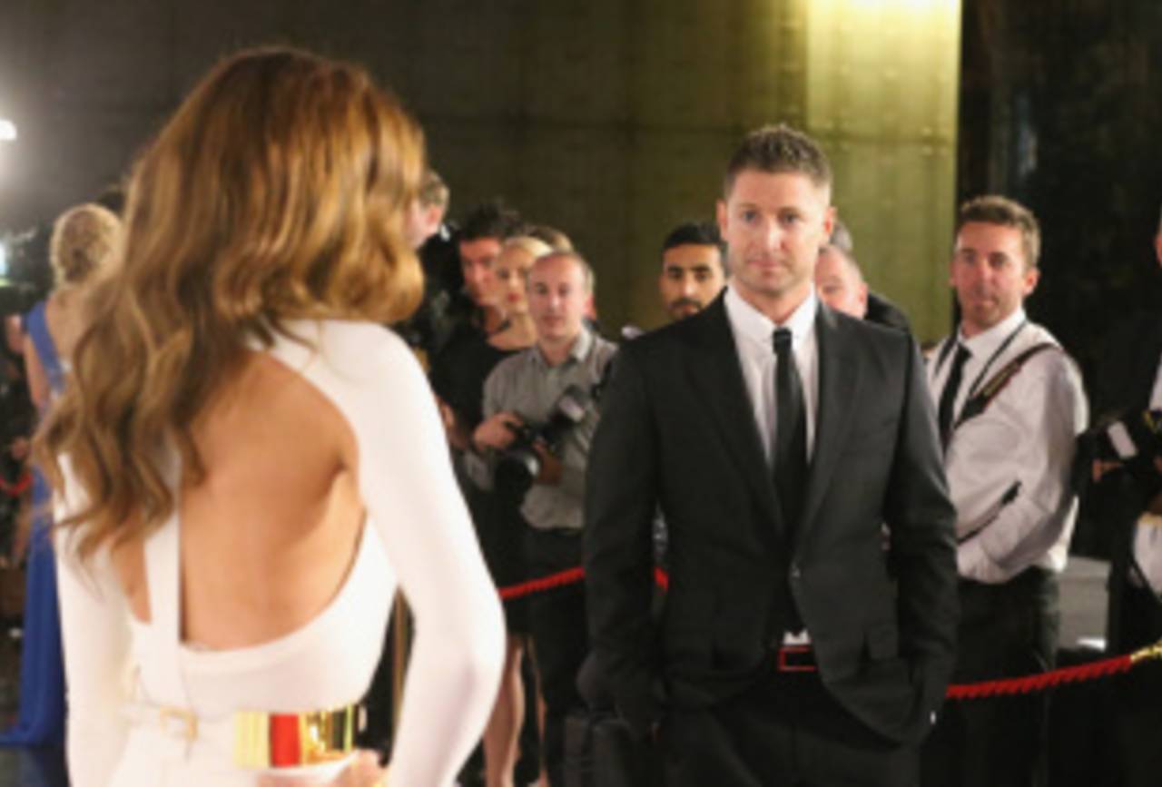 Michael Clarke watches his wife, Kyly, pose for photographs, Melbourne, February 4, 2013