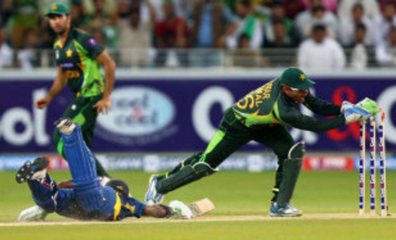 Umar Akmal attempts to run Kusal Perera out, Pakistan v Sri Lanka, 2nd T20, Dubai, December 13, 2013