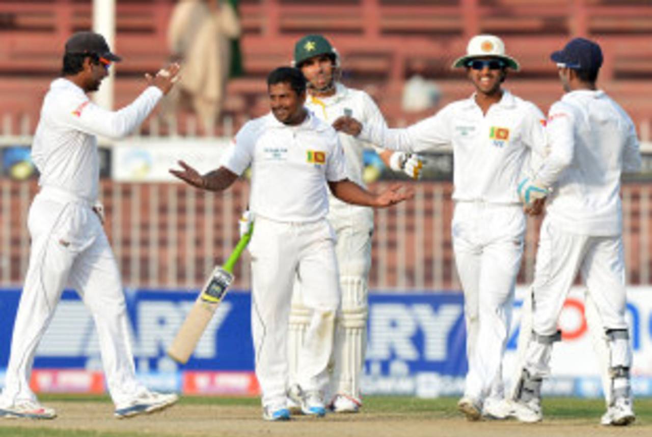 Rangana Herath is congratulated by team-mates after dismissing Ahmed Shehzad, Pakistan v Sri Lanka, 3rd Test, Sharjah, 3rd day, January 18, 2014