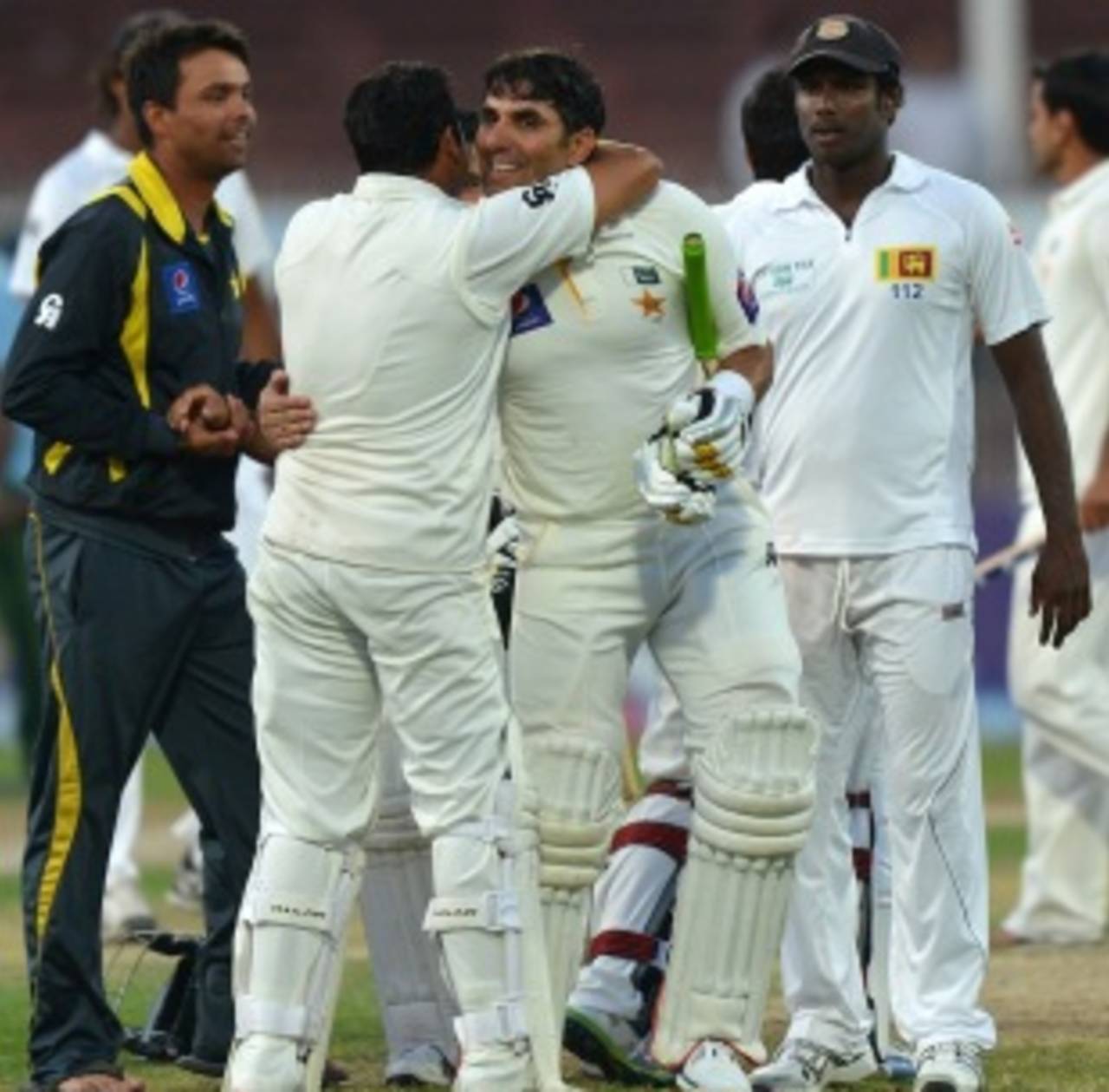 Misbah-ul-Haq is congratulated by team-mates after hitting the winning runs, Pakistan v Sri Lanka, 3rd Test, Sharjah, 5th day, January 20, 2014