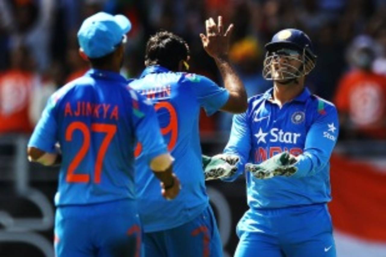R Ashwin celebrates with MS Dhoni after dismissing Corey Anderson, New Zealand v India, 3rd ODI, Auckland, January 25, 2014