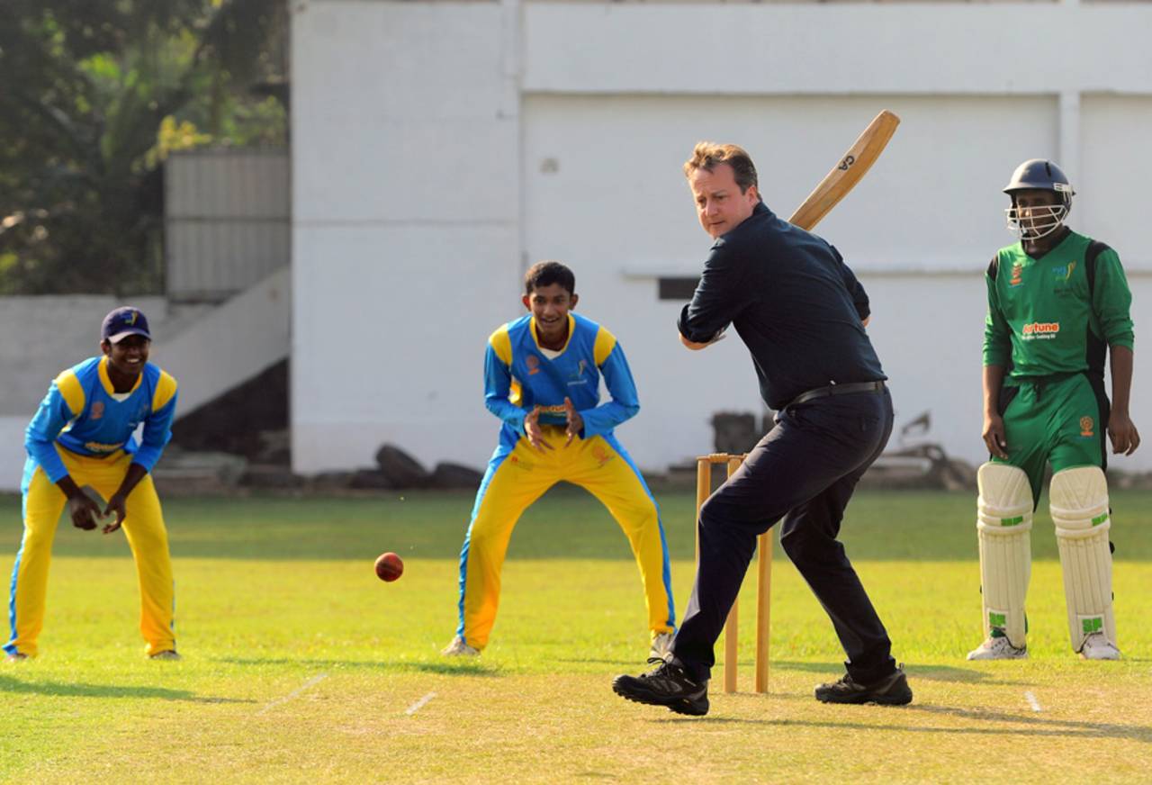 British Prime Minister David Cameron bats during a visit to the Colombo Cricket Club, November 16, 2013