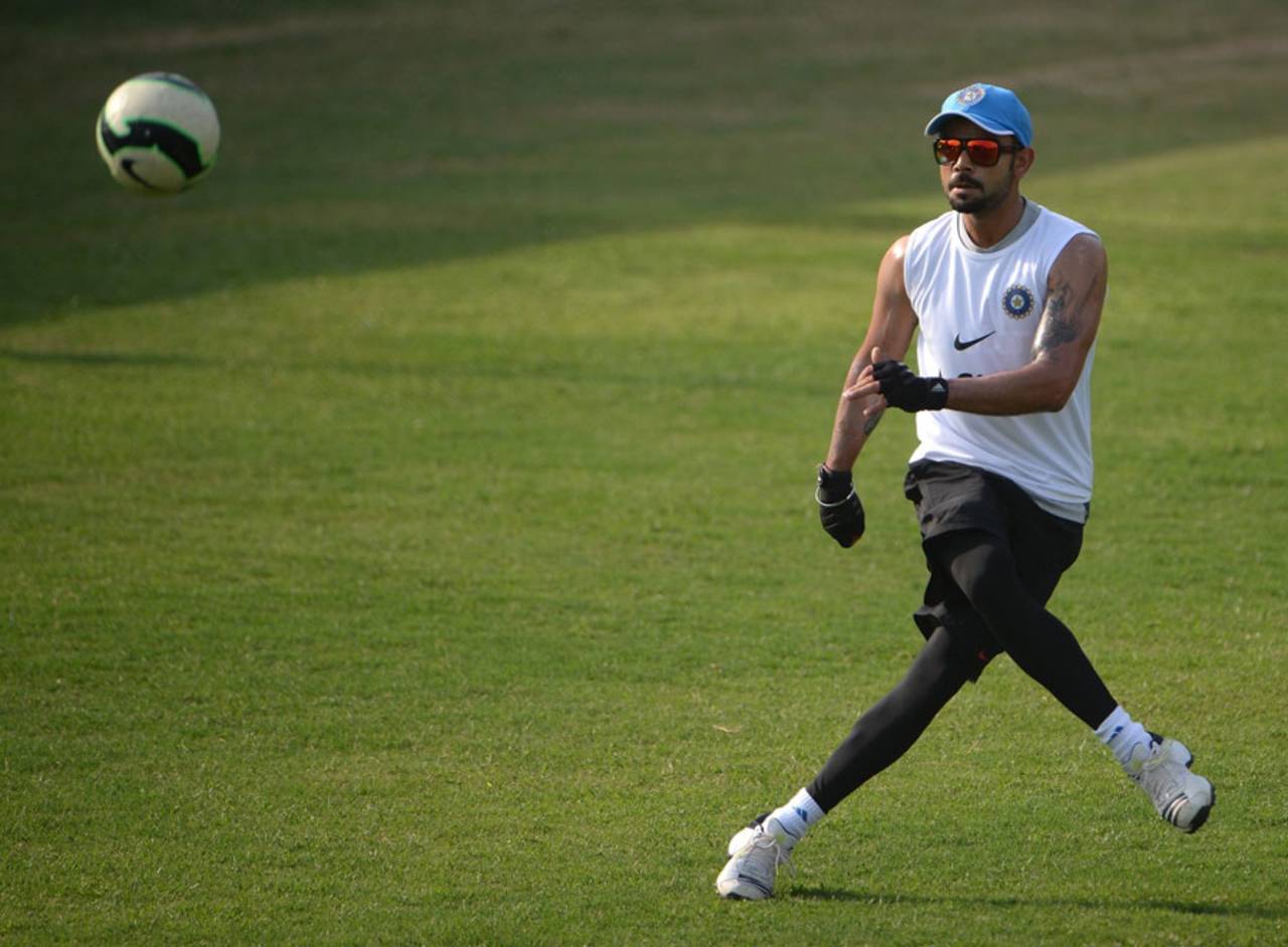 Virat Kohli kicks about a football during a practice session, Dhaka, March 20, 2014