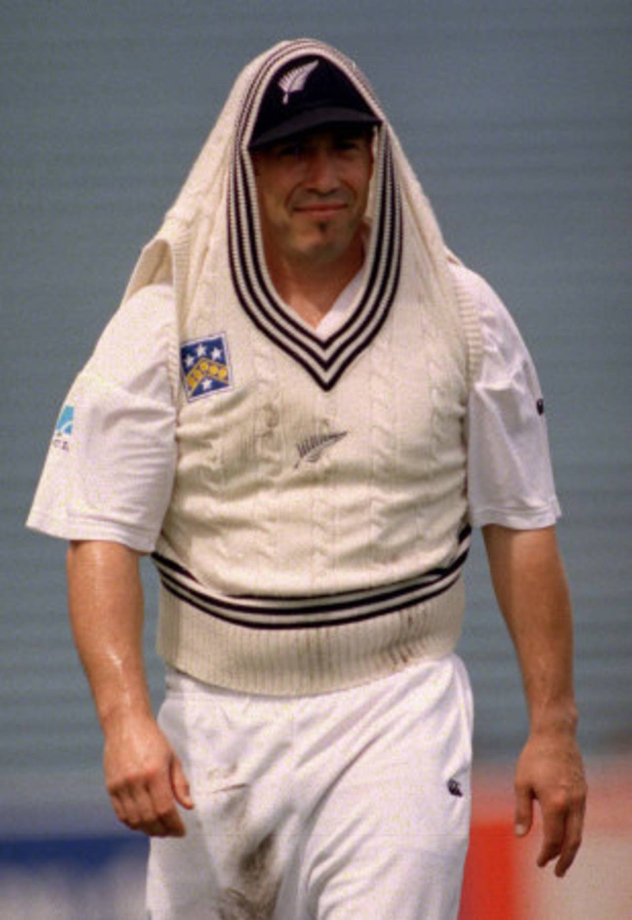 Roger Twose takes cover during a rain interruption, New Zealand v South Africa, 1st Test, Auckland, 1st, February 27, 1999