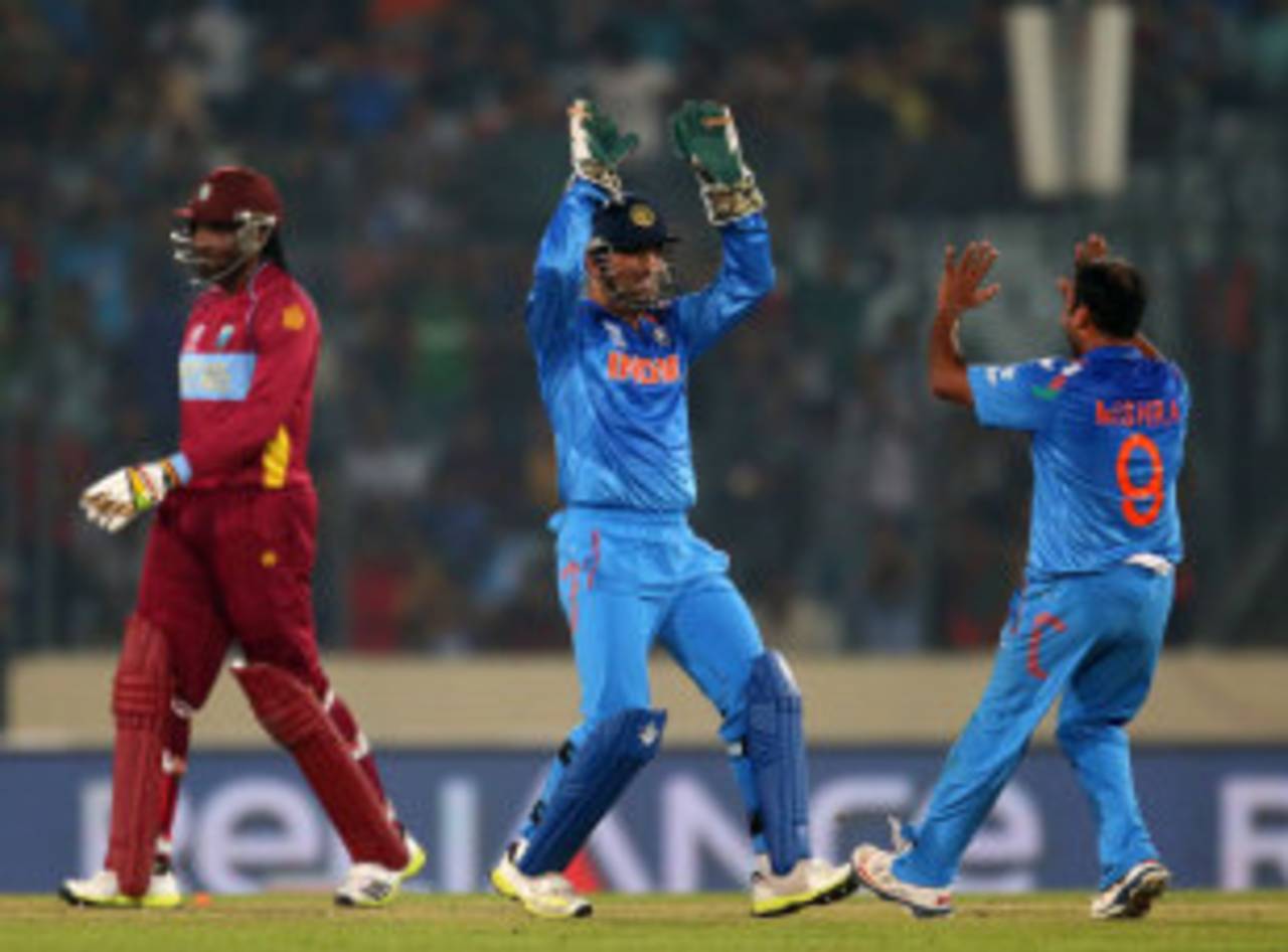 MS Dhoni and Amit Mishra celebrate the run-out of Chris Gayle, India v West Indies, World T20, Group 2, Mirpur, March 23, 2014