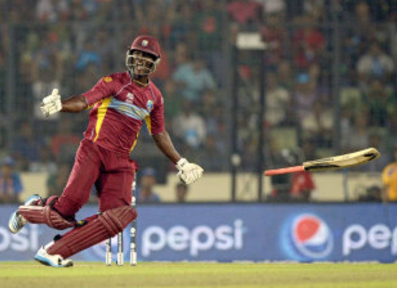 Darren Sammy celebrates the win by tossing his bat in the air, Australia v West Indies, World T20, Group 2, Mirpur, March 28, 2014