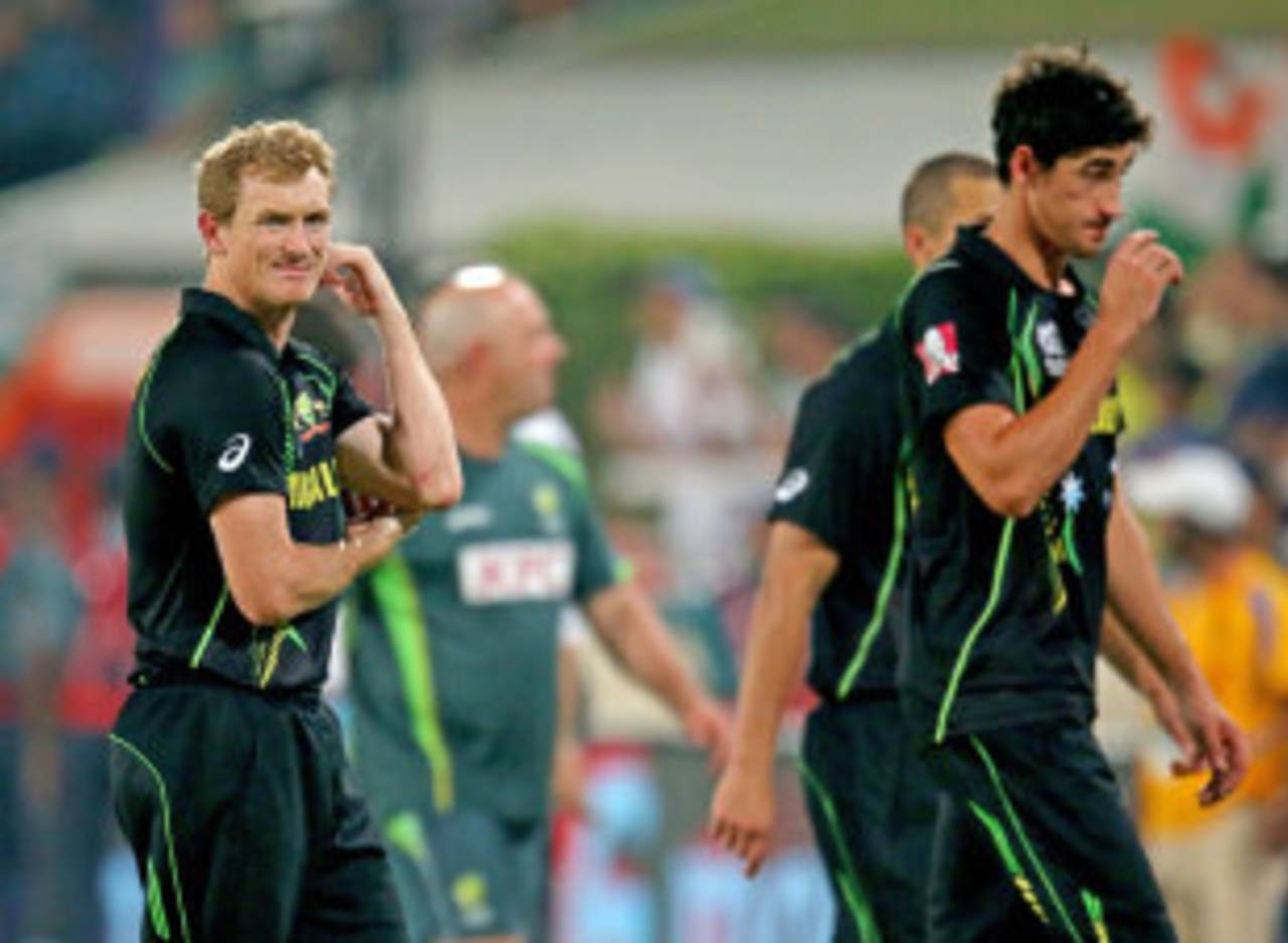 A dejected George Bailey and Mitchell Starc walk off the field, Australia v India, World T20, Group 2, Mirpur, March 30, 2014