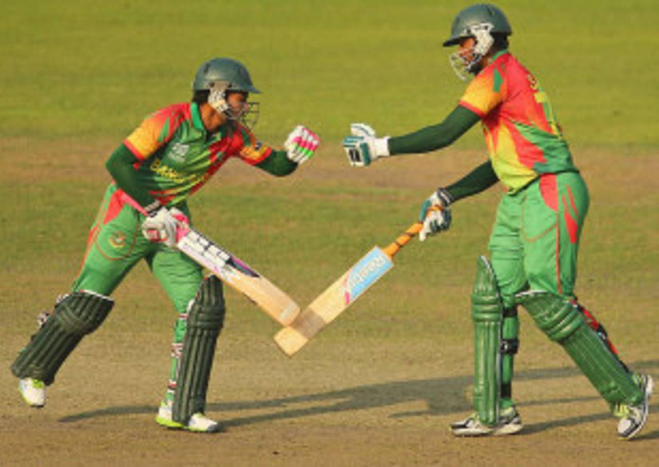 Mushfiqur Rahim and Shakib Al Hasan punch gloves during their stand, Bangladesh v Australia, World T20, Group 2, Mirpur, April 1, 2014