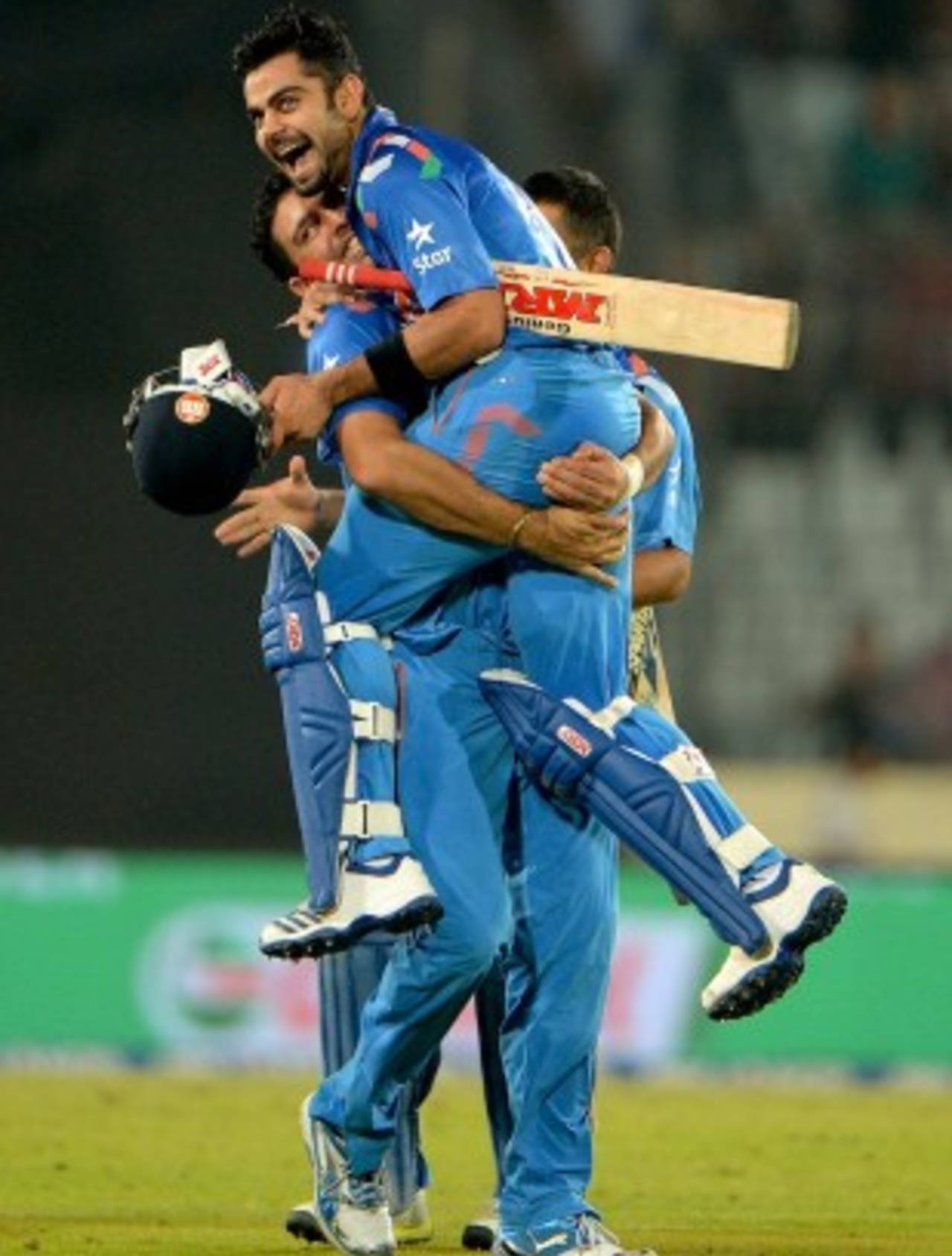 Yuvraj Singh lifts Virat Kohli up after the win, India v South Africa, World T20, semi-final, Mirpur, April 4, 2014