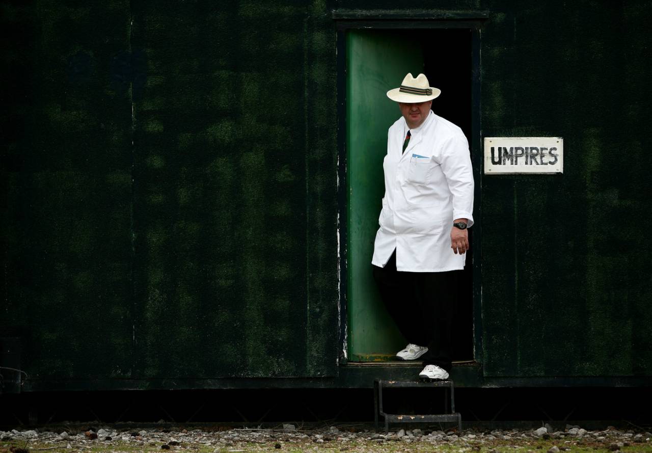 The umpire comes from his room for a game of village cricket at Marchwiel Cricket Club in Wales, July 12, 2008