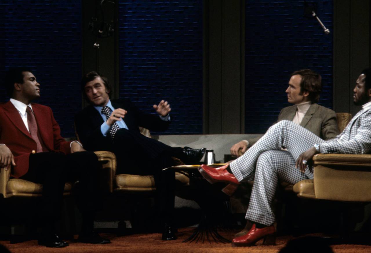 Michael Parkinson (second from left) interviews Muhammad Ali (extreme left) and Joe Frazier (right) with Dick Cavett, January 16, 1974